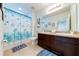 Bathroom with double vanity, shower/tub combo, and fish-themed decor at 4723 Terrasonesta Dr, Davenport, FL 33837
