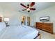 Spacious bedroom with dresser, TV, and ensuite bathroom access at 4723 Terrasonesta Dr, Davenport, FL 33837