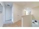 Upstairs hallway with carpet and doors to bedrooms at 4723 Terrasonesta Dr, Davenport, FL 33837