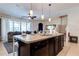 Open kitchen with island and breakfast bar overlooking living room at 4723 Terrasonesta Dr, Davenport, FL 33837