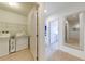 Bright laundry room with washer, dryer, and shelving at 4723 Terrasonesta Dr, Davenport, FL 33837