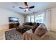 Bright living room featuring comfortable seating and a large TV at 4723 Terrasonesta Dr, Davenport, FL 33837