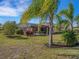 Home with a large backyard, screened patio, and palm trees at 580 Cantabria Dr, Davenport, FL 33837