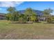 Landscaped backyard with mature trees at 580 Cantabria Dr, Davenport, FL 33837