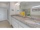 Double vanity bathroom with granite countertop and ample storage at 580 Cantabria Dr, Davenport, FL 33837