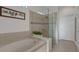 Spa-like bathroom featuring a soaking tub and a glass-enclosed shower at 580 Cantabria Dr, Davenport, FL 33837