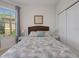 Cozy bedroom featuring a comfortable bed and large window at 580 Cantabria Dr, Davenport, FL 33837