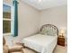 Charming bedroom with a metal bed frame and window at 580 Cantabria Dr, Davenport, FL 33837