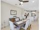 Elegant dining room with a wood table and six light beige chairs at 580 Cantabria Dr, Davenport, FL 33837