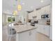 Bright kitchen boasts an expansive island, white cabinetry, and breakfast nook at 580 Cantabria Dr, Davenport, FL 33837