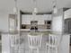 Island kitchen with seating for three and granite countertops at 580 Cantabria Dr, Davenport, FL 33837