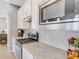 Kitchen detail showing cooktop, oven, microwave and granite countertops at 580 Cantabria Dr, Davenport, FL 33837
