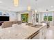 Open kitchen with large island, stainless steel appliances, and view of living area at 580 Cantabria Dr, Davenport, FL 33837