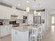Modern kitchen with white cabinets, granite countertops, and stainless steel appliances at 580 Cantabria Dr, Davenport, FL 33837