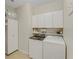 Convenient laundry room with washer, dryer, and storage at 580 Cantabria Dr, Davenport, FL 33837