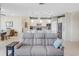 Relaxing living room with gray sofas and access to dining area at 580 Cantabria Dr, Davenport, FL 33837