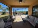 Covered patio with comfortable seating overlooking the pool at 580 Cantabria Dr, Davenport, FL 33837