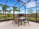 Enclosed patio with dining set, offering scenic views at 580 Cantabria Dr, Davenport, FL 33837