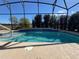 Screened pool with a tranquil waterfall feature at 580 Cantabria Dr, Davenport, FL 33837