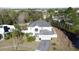 Two-story house with a gray roof, driveway, and canal behind the property at 605 Pinehurst Ct, Kissimmee, FL 34758