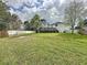 Large backyard with lush grass and privacy fence at 605 Pinehurst Ct, Kissimmee, FL 34758