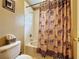 Bathroom with tub shower and animal print shower curtain at 605 Pinehurst Ct, Kissimmee, FL 34758