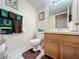 Guest bathroom with wood vanity and toilet at 605 Pinehurst Ct, Kissimmee, FL 34758
