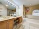 Bathroom boasts a double vanity, soaking tub, and separate shower at 605 Pinehurst Ct, Kissimmee, FL 34758