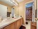 Double vanity bathroom with a shower/tub combo at 605 Pinehurst Ct, Kissimmee, FL 34758