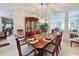 Formal dining room with a large wooden table and chandelier at 605 Pinehurst Ct, Kissimmee, FL 34758
