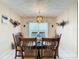 Dining room with dark wood table and chairs, and a chandelier at 605 Pinehurst Ct, Kissimmee, FL 34758