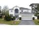 Two-story house with a gray roof, white exterior, and a two-car garage at 605 Pinehurst Ct, Kissimmee, FL 34758