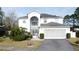 Two-story house with a two-car garage and nicely landscaped front yard at 605 Pinehurst Ct, Kissimmee, FL 34758