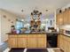 Open kitchen with island, granite countertops, and breakfast bar at 605 Pinehurst Ct, Kissimmee, FL 34758