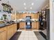 Bright kitchen featuring wood cabinets and black appliances at 605 Pinehurst Ct, Kissimmee, FL 34758