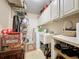 Laundry room with washer, dryer, and storage shelves at 605 Pinehurst Ct, Kissimmee, FL 34758