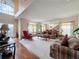 Living room with hardwood floors, red armchair, and high ceilings at 605 Pinehurst Ct, Kissimmee, FL 34758