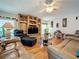 Gathering room with built-in shelving, hardwood floors, and two sofas at 605 Pinehurst Ct, Kissimmee, FL 34758