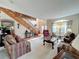 Living room with hardwood floors, two sofas, and a high ceiling at 605 Pinehurst Ct, Kissimmee, FL 34758