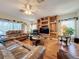 Bright living room featuring hardwood floors, leather furniture, and a ceiling fan at 605 Pinehurst Ct, Kissimmee, FL 34758