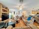 Spacious living room with hardwood floors, comfortable leather furniture, and built-in shelving at 605 Pinehurst Ct, Kissimmee, FL 34758