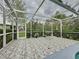 Screened patio with table and chairs at 605 Pinehurst Ct, Kissimmee, FL 34758