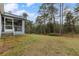 Large backyard with grassy area and wooded backdrop at 832 Marion Oaks Mnr, Ocala, FL 34473