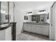 Double vanity bathroom with granite countertop and large mirror at 832 Marion Oaks Mnr, Ocala, FL 34473