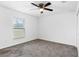 Simple bedroom with carpet flooring and a window at 832 Marion Oaks Mnr, Ocala, FL 34473