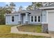 Front entrance of a newly constructed home with a walkway and landscaping at 832 Marion Oaks Mnr, Ocala, FL 34473