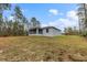 Gray house exterior with screened porch and backyard view at 832 Marion Oaks Mnr, Ocala, FL 34473