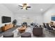 Modern living room featuring a gray sofa, neutral walls, and a patterned rug at 832 Marion Oaks Mnr, Ocala, FL 34473