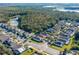 Aerial view of a residential neighborhood with a lake nearby at 1201 Winding Willow Ct, Kissimmee, FL 34746