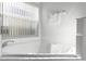 Relaxing corner bathtub with bright, clean tile surround at 1201 Winding Willow Ct, Kissimmee, FL 34746